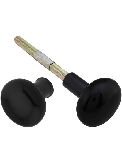 Pair of Black Porcelain Rim Lock Knobs with Black Iron Shanks - 1 3/4 inch Diameter.